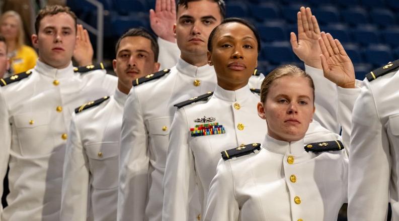 ROTC students hold up right hand to take an oath
